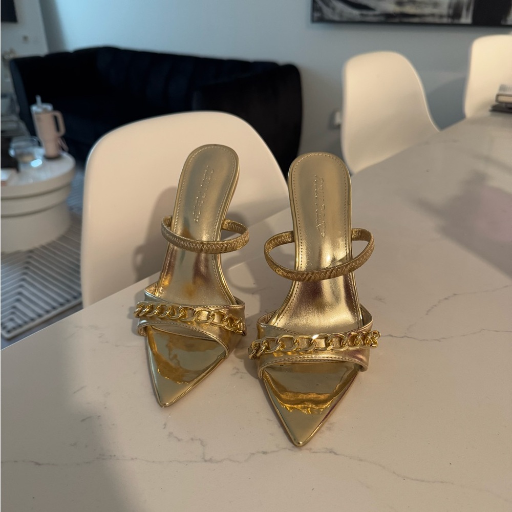 Gold stiletto heels with chain detail